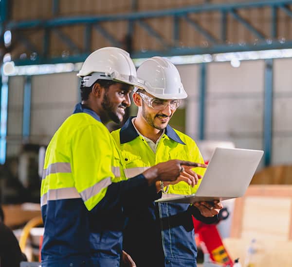 Men in hard hats on laptop